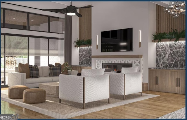 0 Ebenezer Rd Unit 4, Fayetteville, GA 30215 - living area featuring a high ceiling, wood finished floors, a chandelier, a glass covered fireplace, and a ceiling fan