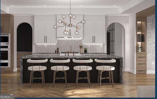 0 Ebenezer Rd Unit 4, Fayetteville, GA 30215 - kitchen with arched walkways, a sink, appliances with stainless steel finishes, a chandelier, and a breakfast bar area