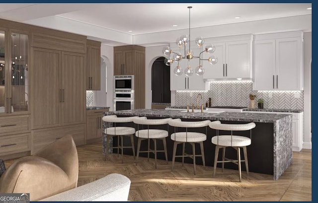 0 Ebenezer Rd Unit 4, Fayetteville, GA 30215 - kitchen with an island with sink, backsplash, a chandelier, a kitchen bar, and recessed lighting