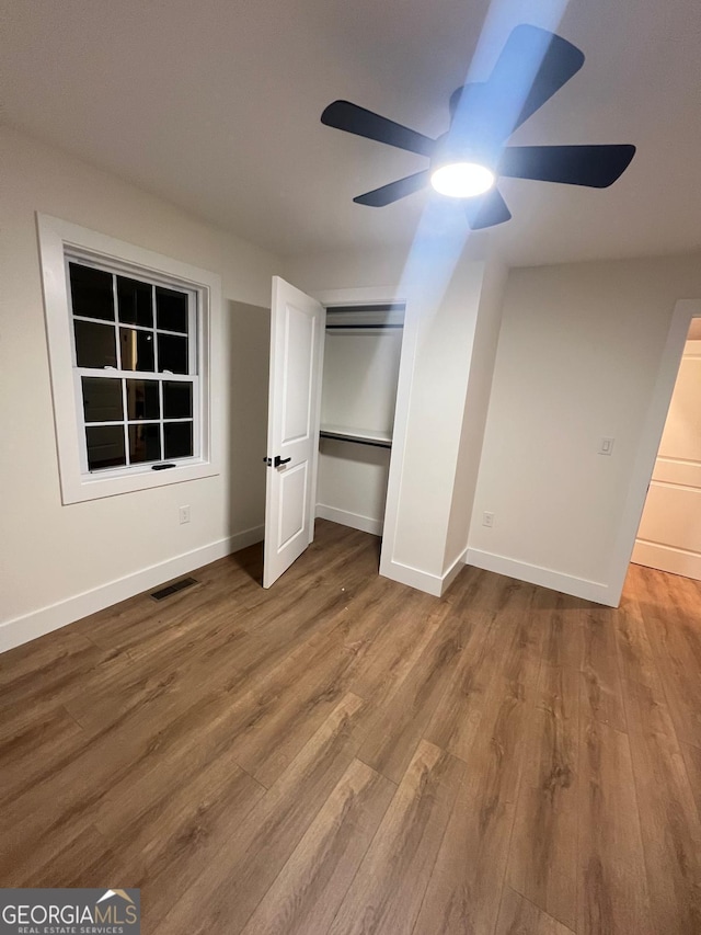 1227 Kenilworth Dr SW, Atlanta, GA 30310 - unfurnished bedroom featuring wood finished floors, a closet, ceiling fan, and baseboards