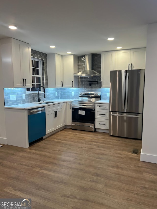 1227 Kenilworth Dr SW, Atlanta, GA 30310 - kitchen featuring stainless steel appliances, wall chimney range hood, backsplash, light countertops, and recessed lighting
