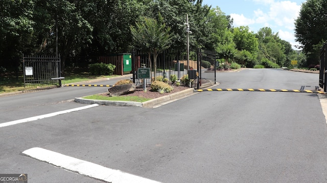636 N Ave Unit 11E, Jonesboro, GA 30236 - view of asphalt street with curbs, a gate, and a gated entry