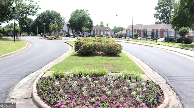636 N Ave Unit 11E, Jonesboro, GA 30236 - view of asphalt road with street lights, a residential view, and curbs