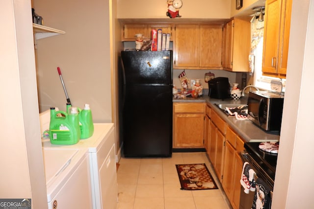 636 N Ave Unit 11E, Jonesboro, GA 30236 - kitchen with freestanding refrigerator, washer and dryer, gas stove, light tile patterned floors, and stainless steel microwave
