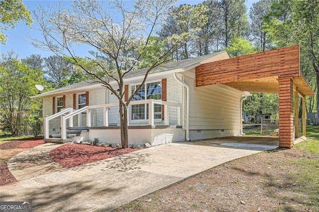 4201 Regal Ridge Rd, Austell, GA 30106 - view of front facade with driveway, an attached carport, brick siding, and crawl space