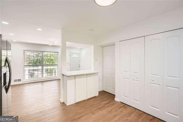 4201 Regal Ridge Rd, Austell, GA 30106 - kitchen featuring light wood finished floors, refrigerator with ice dispenser, light countertops, recessed lighting, and white cabinetry