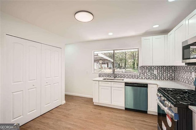 4201 Regal Ridge Rd, Austell, GA 30106 - kitchen featuring stainless steel appliances, white cabinetry, a sink, backsplash, and recessed lighting