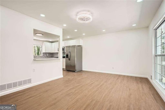 4201 Regal Ridge Rd, Austell, GA 30106 - unfurnished living room featuring light wood-style flooring, recessed lighting, and baseboards