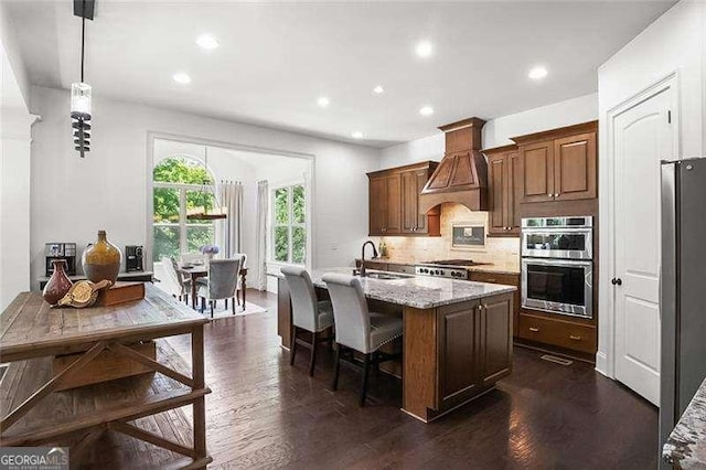 715 Creekside Bnd, Alpharetta, GA 30004 - kitchen with a sink, custom range hood, stainless steel double oven, decorative backsplash, and dark wood-style flooring
