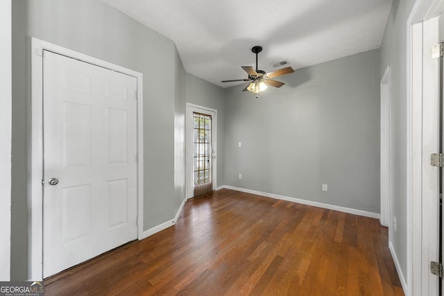 1995 Liberty Hts, Fairburn, GA 30213 - unfurnished bedroom featuring dark wood-style flooring, baseboards, and a ceiling fan