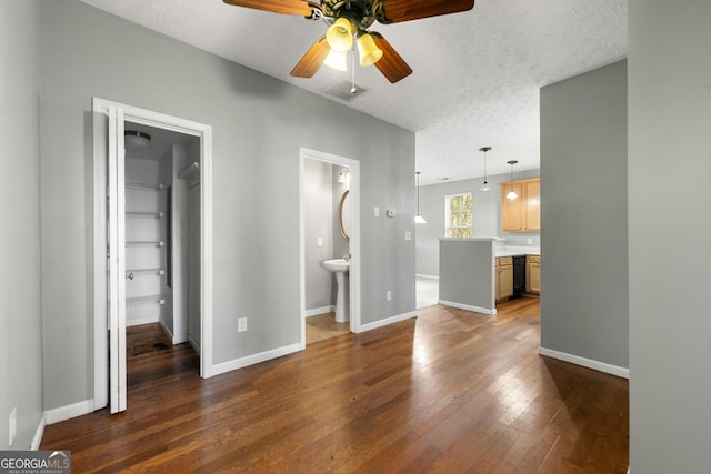 1995 Liberty Hts, Fairburn, GA 30213 - unfurnished living room with ceiling fan, dark wood-style flooring, baseboards, and a textured ceiling