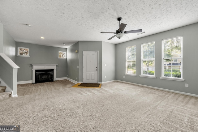 1995 Liberty Hts, Fairburn, GA 30213 - unfurnished living room with a fireplace, baseboards, ceiling fan, carpet floors, and stairs