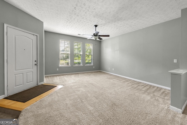 1995 Liberty Hts, Fairburn, GA 30213 - carpeted foyer entrance with ceiling fan, baseboards, and a textured ceiling