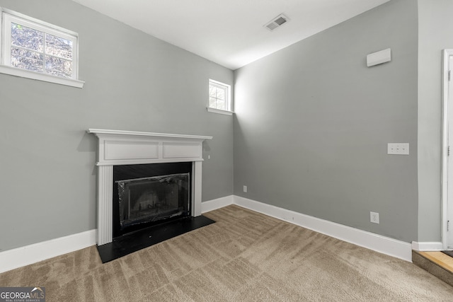 1995 Liberty Hts, Fairburn, GA 30213 - unfurnished living room featuring carpet, a fireplace with flush hearth, and baseboards