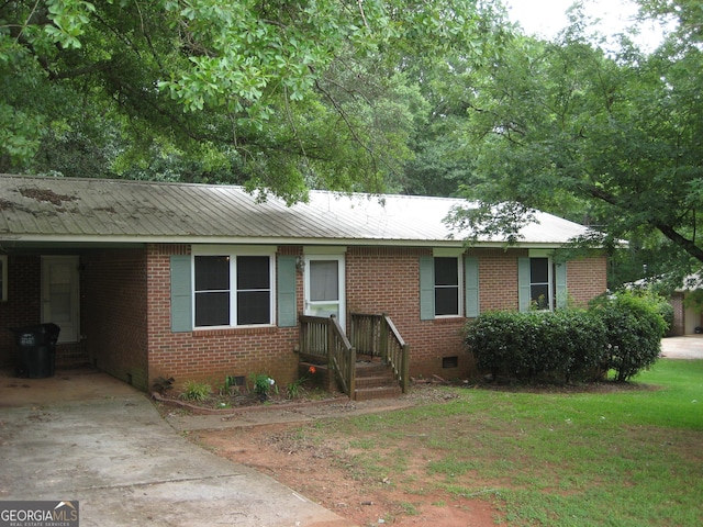 167 Franklin St, Zebulon, GA 30295 - ranch-style house featuring crawl space, an attached carport, a metal roof, concrete driveway, and brick siding