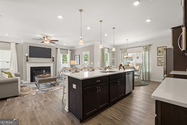2690 Ravencliff Dr, Austell, GA 30168 - kitchen with stainless steel appliances, ornamental molding, light countertops, ceiling fan, and open floor plan
