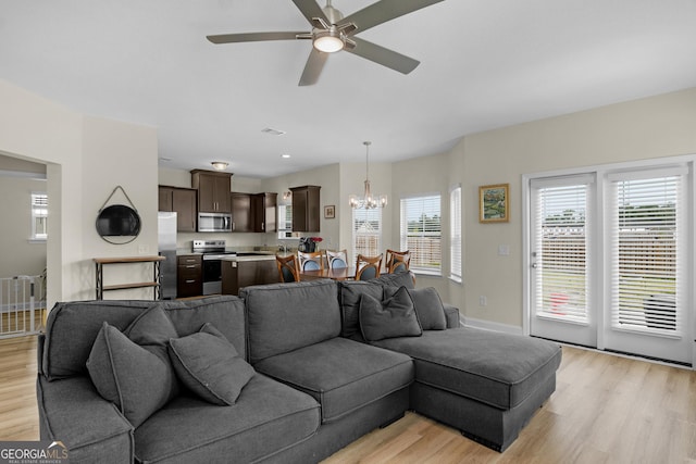 935 Abode Ave, Fort Stewart, GA 31313 - living room featuring light wood-type flooring, a chandelier, and plenty of natural light