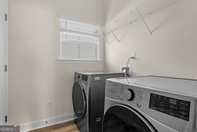 935 Abode Ave, Fort Stewart, GA 31313 - laundry room with washing machine and clothes dryer, baseboards, and wood finished floors