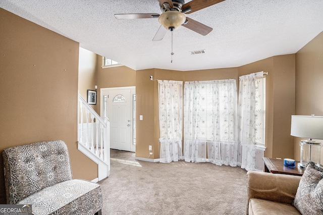 3740 Arminto Dr, Ellenwood, GA 30294 - sitting room featuring carpet floors, ceiling fan, stairs, and a textured ceiling