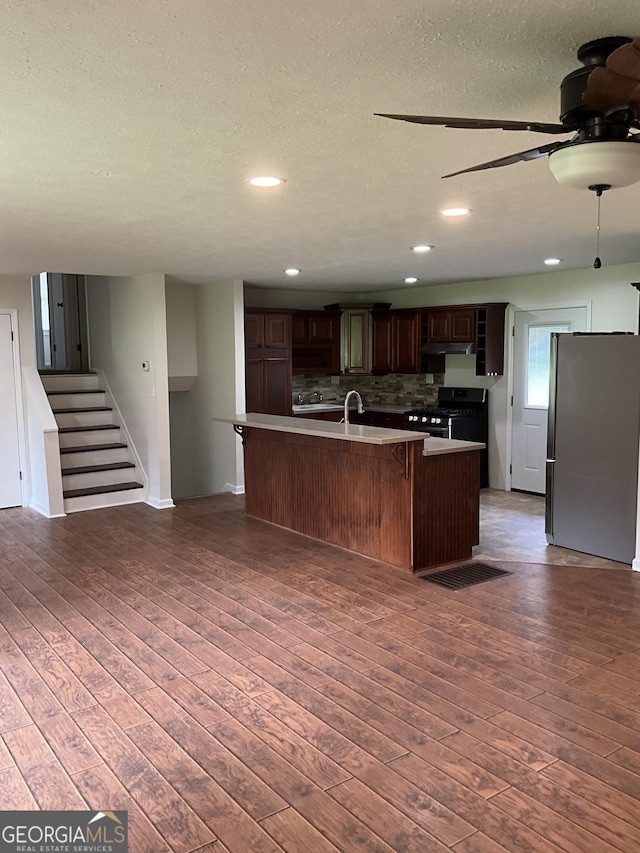 1776 Smokey Rd, Lagrange, GA 30241 - kitchen with appliances with stainless steel finishes, a ceiling fan, decorative backsplash, wood finished floors, and open floor plan