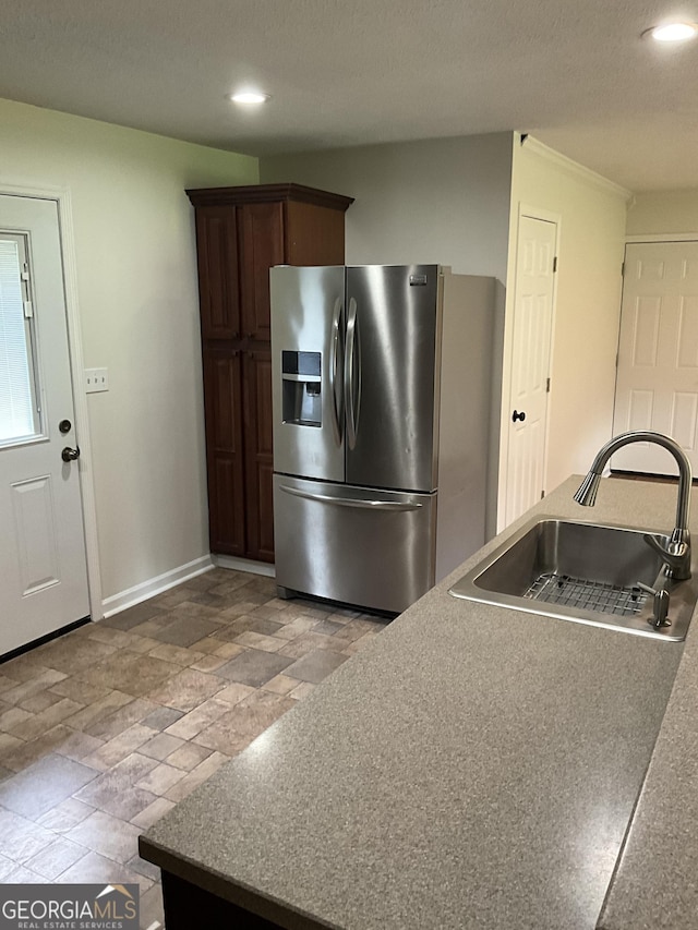 1776 Smokey Rd, Lagrange, GA 30241 - kitchen with stainless steel fridge with ice dispenser, a sink, stone tile floors, recessed lighting, and baseboards