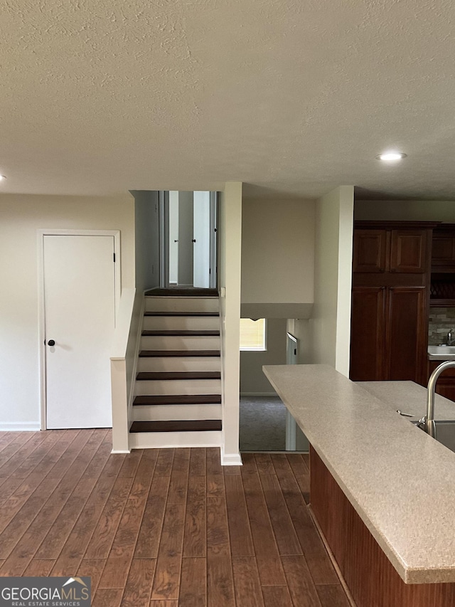 1776 Smokey Rd, Lagrange, GA 30241 - staircase featuring a textured ceiling, wood-type flooring, recessed lighting, and baseboards