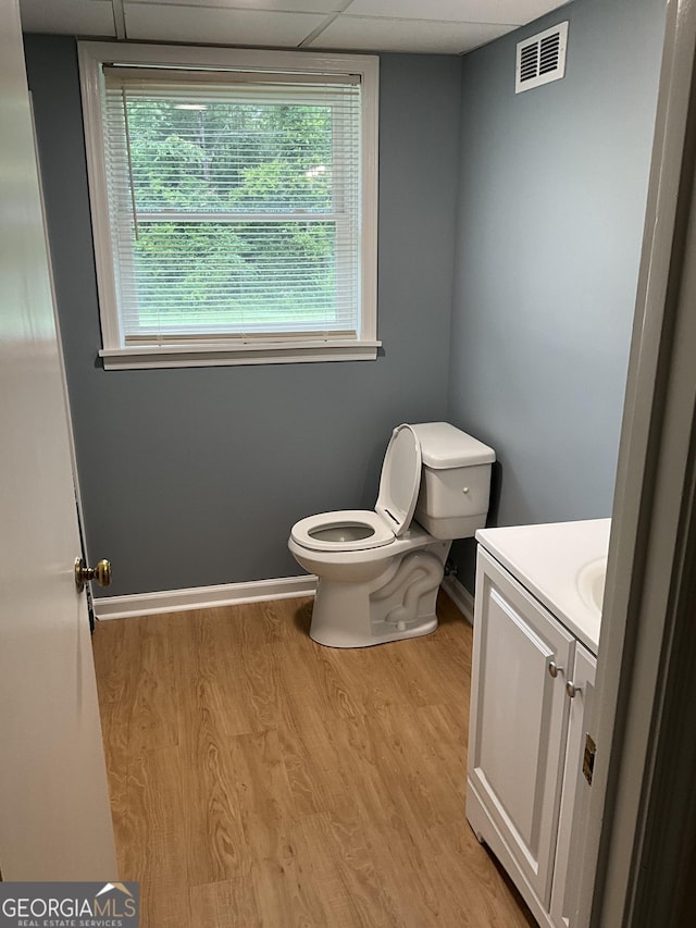 1776 Smokey Rd, Lagrange, GA 30241 - bathroom with toilet, vanity, wood finished floors, a drop ceiling, and baseboards