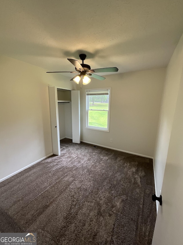 1776 Smokey Rd, Lagrange, GA 30241 - unfurnished bedroom featuring dark colored carpet, a closet, baseboards, and a ceiling fan