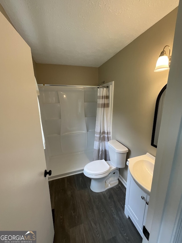 1776 Smokey Rd, Lagrange, GA 30241 - bathroom featuring vanity, toilet, wood finished floors, a textured ceiling, and a shower with curtain