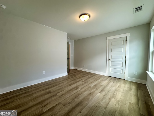 7040 Manchester Dr, Flowery Branch, GA 30542 - unfurnished room featuring wood finished floors and baseboards