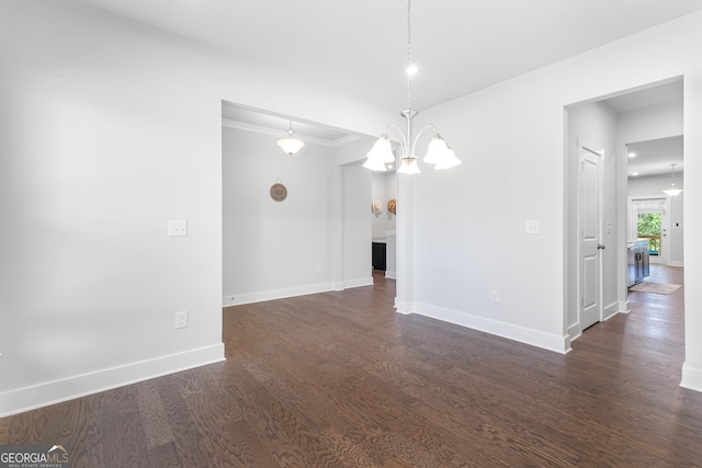 411 Riverclub Rd, Acworth, GA 30101 - spare room with dark wood-style floors, a chandelier, baseboards, and crown molding