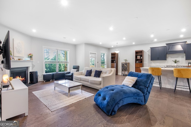 411 Riverclub Rd, Acworth, GA 30101 - living room with recessed lighting, dark wood-type flooring, a glass covered fireplace, and baseboards