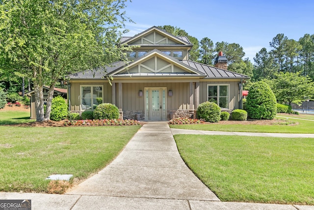 411 Riverclub Rd, Acworth, GA 30101 - view of front of home featuring a standing seam roof, board and batten siding, a front lawn, a chimney, and metal roof