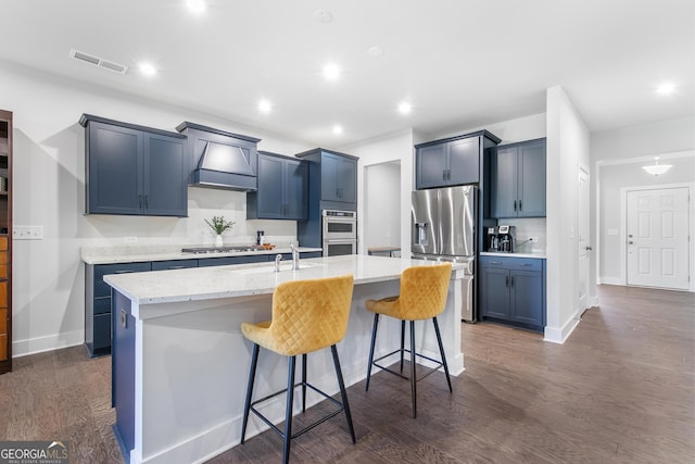 411 Riverclub Rd, Acworth, GA 30101 - kitchen with stainless steel appliances, a sink, custom exhaust hood, an island with sink, and a kitchen breakfast bar