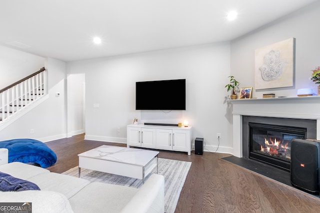 411 Riverclub Rd, Acworth, GA 30101 - living room with dark wood-type flooring, a glass covered fireplace, stairway, recessed lighting, and baseboards