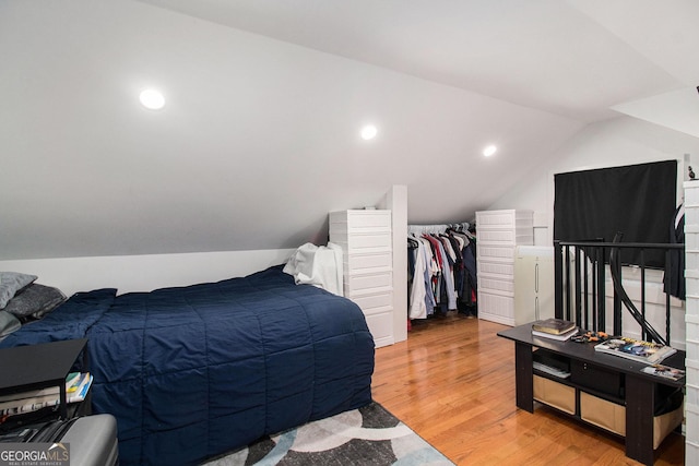 1292 Eubanks Ave, East Point, GA 30344 - bedroom with light wood finished floors, lofted ceiling, and washer / dryer