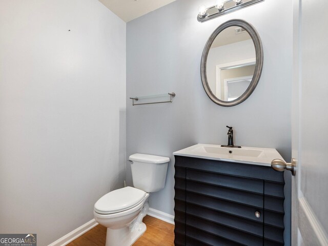 6439 Mossy Boulder Dr, Flowery Branch, GA 30542 - bathroom with wood finished floors and vanity