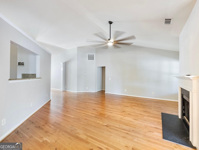 6439 Mossy Boulder Dr, Flowery Branch, GA 30542 - unfurnished living room with vaulted ceiling, a ceiling fan, a fireplace with flush hearth, and wood finished floors