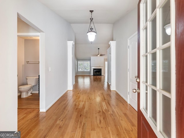 6439 Mossy Boulder Dr, Flowery Branch, GA 30542 - corridor with light wood finished floors and vaulted ceiling
