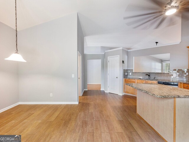 6439 Mossy Boulder Dr, Flowery Branch, GA 30542 - kitchen with vaulted ceiling, light wood-type flooring, backsplash, pendant lighting, and dishwashing machine