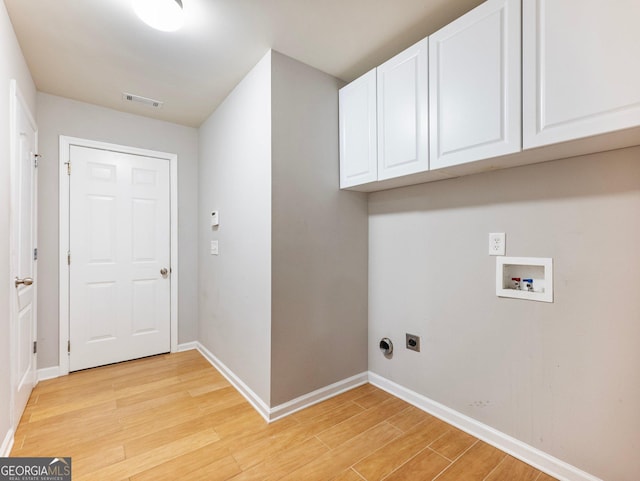 6439 Mossy Boulder Dr, Flowery Branch, GA 30542 - laundry room featuring hookup for a washing machine, cabinet space, electric dryer hookup, and light wood finished floors