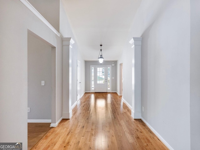 6439 Mossy Boulder Dr, Flowery Branch, GA 30542 - foyer entrance featuring light wood-style flooring, decorative columns, and ornamental molding