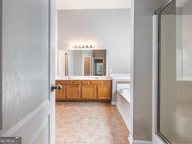 6439 Mossy Boulder Dr, Flowery Branch, GA 30542 - bathroom with a stall shower, double vanity, a garden tub, and tile patterned floors