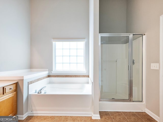6439 Mossy Boulder Dr, Flowery Branch, GA 30542 - full bathroom with a shower stall, a garden tub, and tile patterned flooring