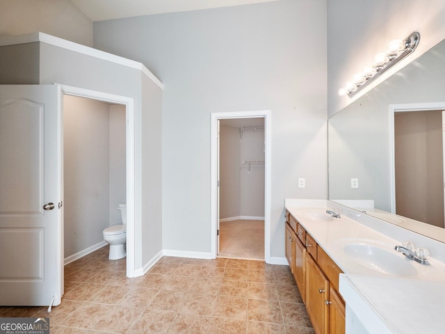 6439 Mossy Boulder Dr, Flowery Branch, GA 30542 - full bathroom with double vanity, tile patterned floors, and a spacious closet