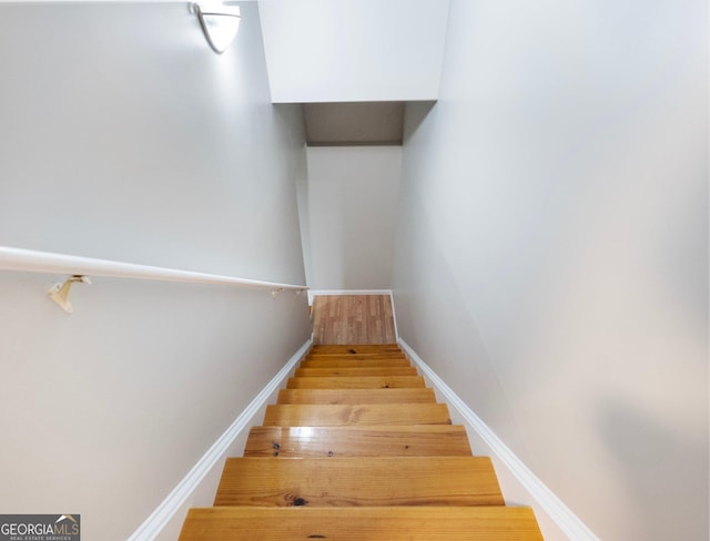 6439 Mossy Boulder Dr, Flowery Branch, GA 30542 - staircase featuring wood finished floors and baseboards