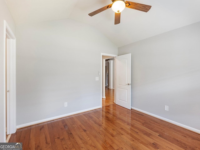 6439 Mossy Boulder Dr, Flowery Branch, GA 30542 - unfurnished bedroom with lofted ceiling, wood finished floors, and ceiling fan