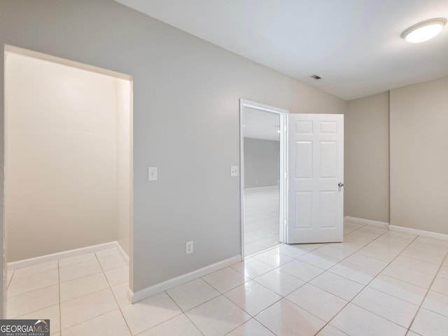 6439 Mossy Boulder Dr, Flowery Branch, GA 30542 - spare room with light tile patterned flooring and lofted ceiling