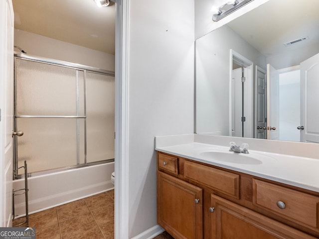 6439 Mossy Boulder Dr, Flowery Branch, GA 30542 - bathroom featuring vanity, bath / shower combo with glass door, and tile patterned floors