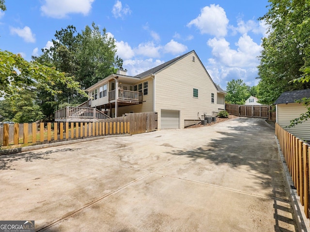 6439 Mossy Boulder Dr, Flowery Branch, GA 30542 - back of house featuring an attached garage and concrete driveway